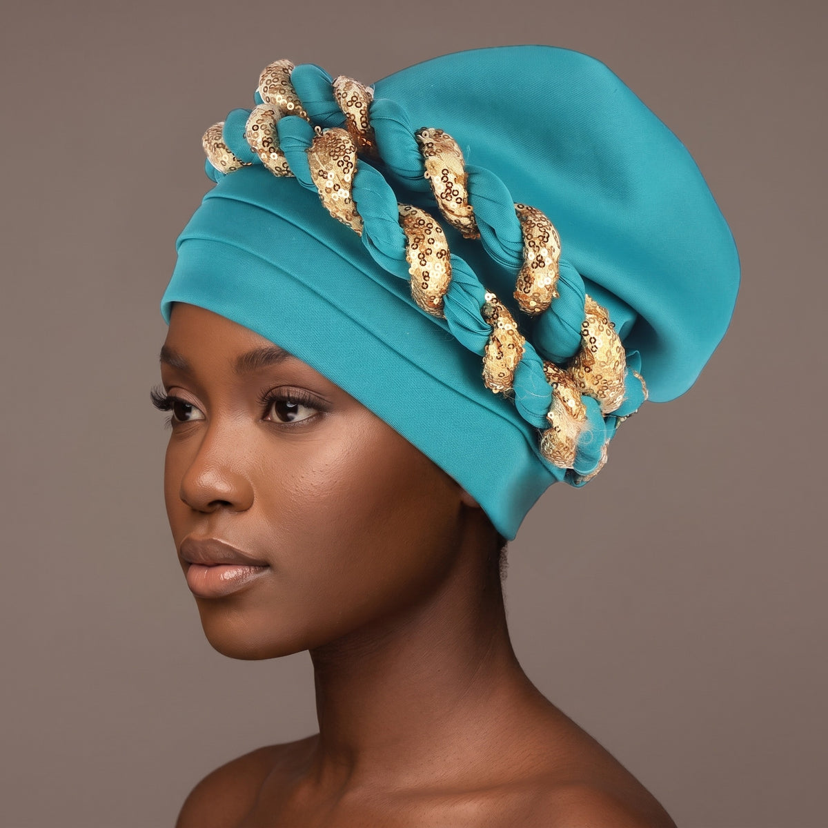 Woman wearing the lake blue sequin braided turban