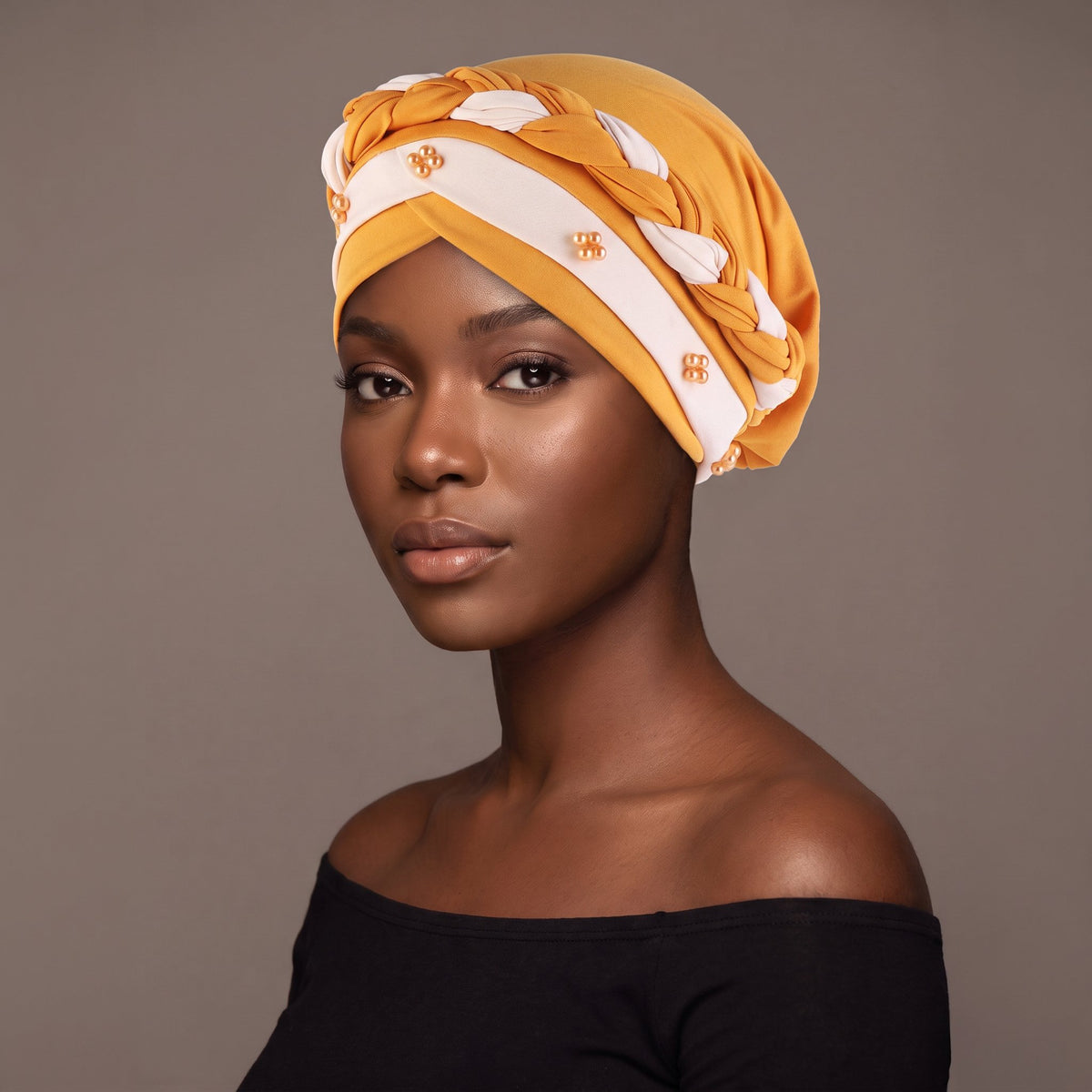 Woman wearing the mustard and white three-layer twist turban
