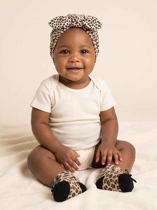 Baby girl wearing the leopard turban and matching socks