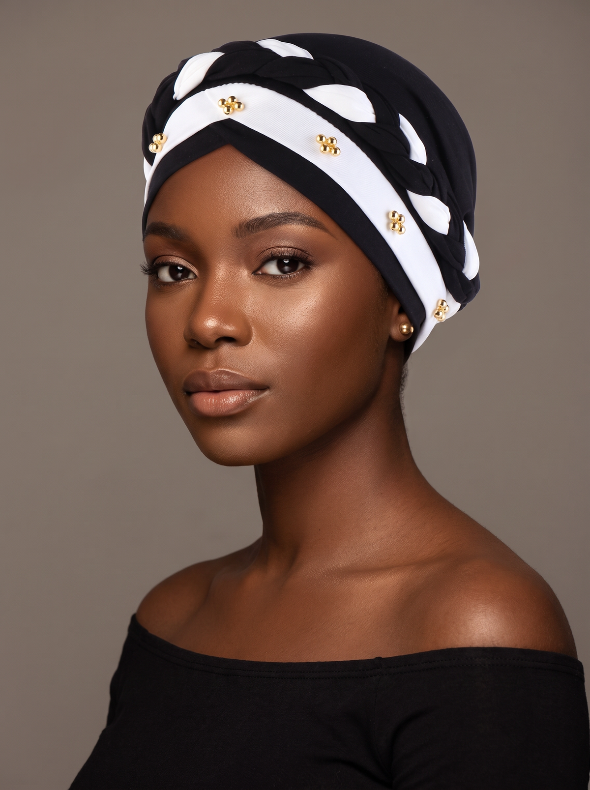 Woman wearing the black and white three-layer twist turban hat