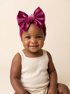 Toddler girl wearing the magenta velvet bow turban headband