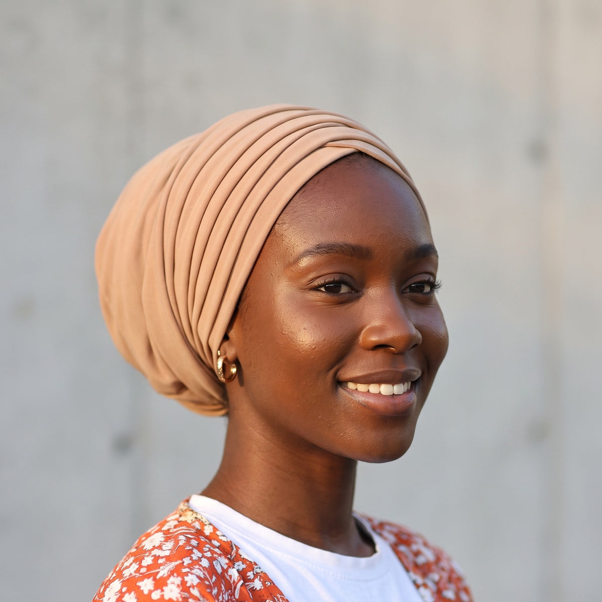 Woman wearing the caramel Dubai pre-tied turban