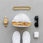 Flat-lay of the white halo turban with gold chain, watch and sneakers