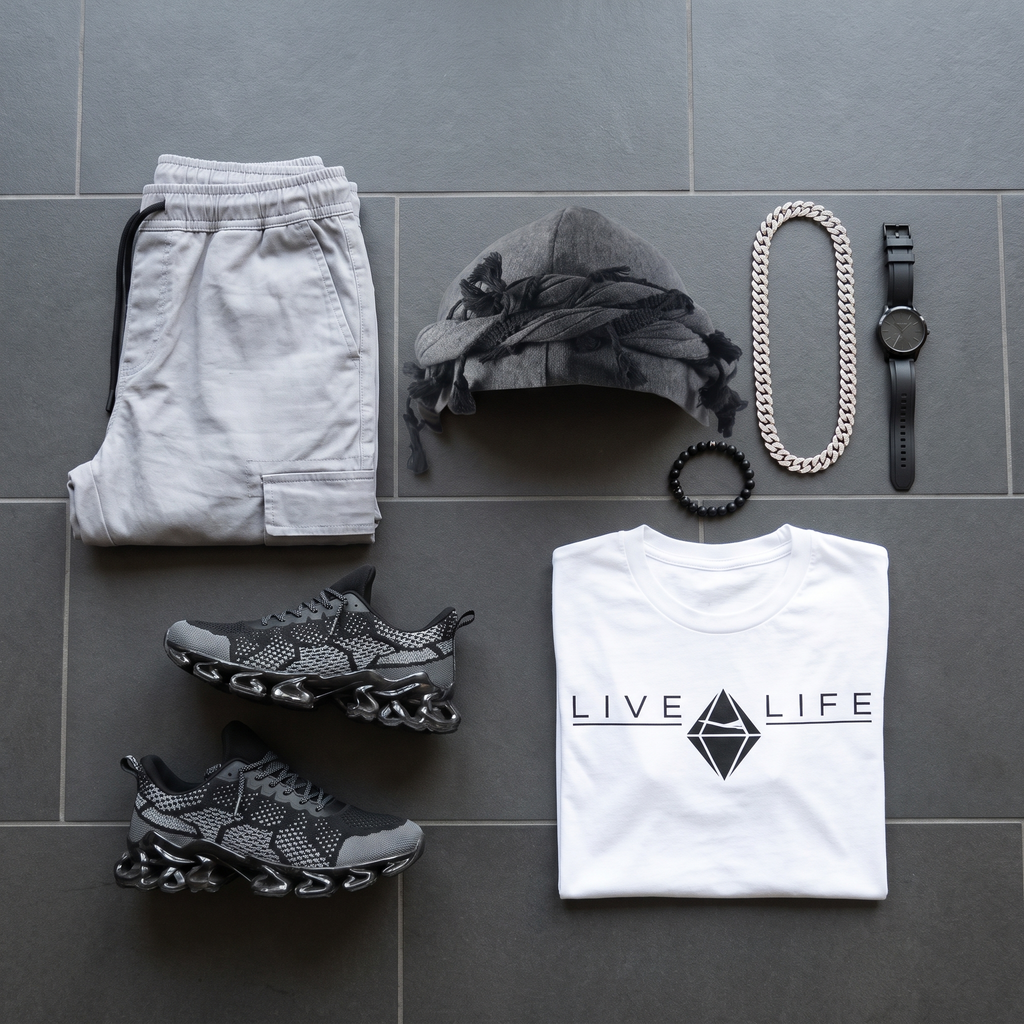 Flat-lay of the grey twist turban with tassels, LIVE LIFE tee, grey cargo joggers, sneakers and chain