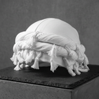 White halo turban with tassels on a slate block, side view