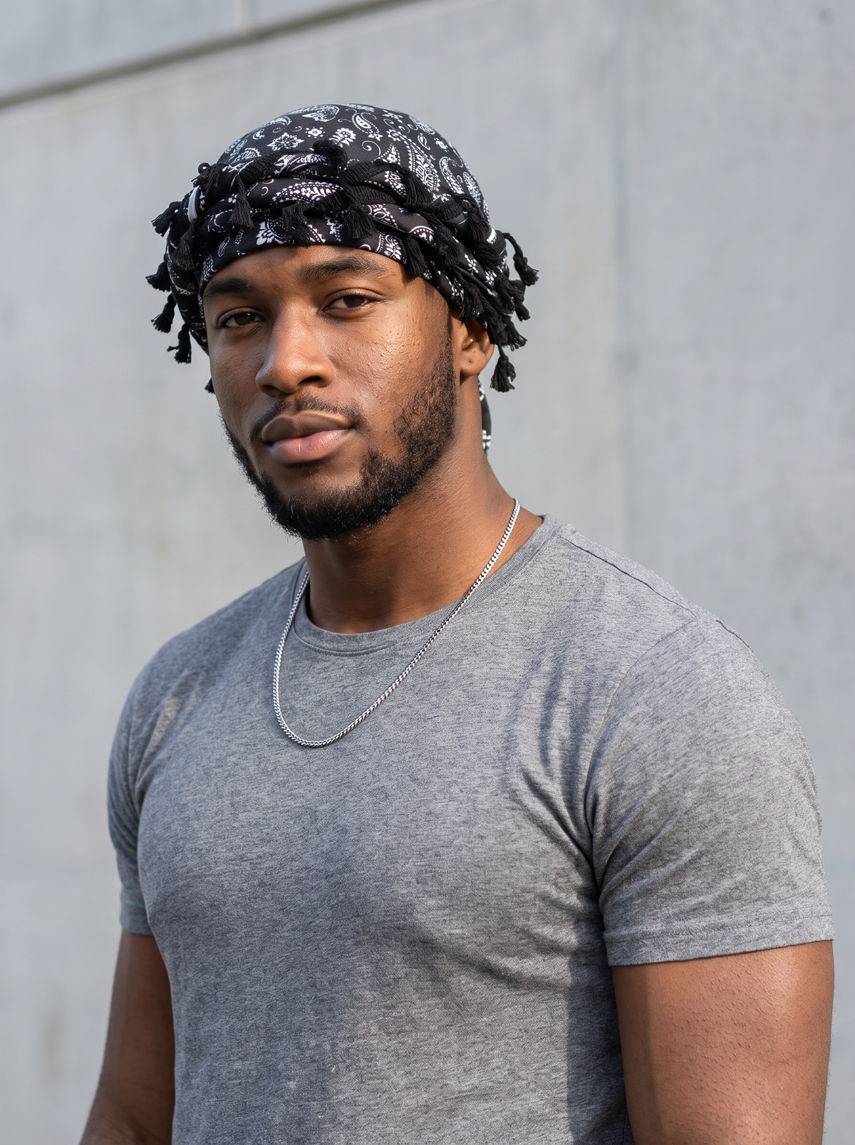 Man wearing the black paisley tassel turban